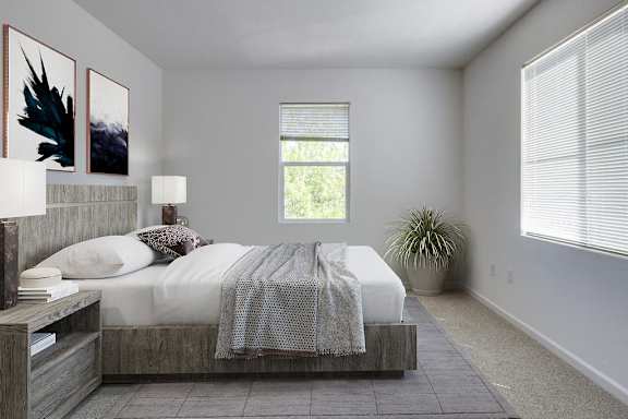 a bedroom with a bed and two windows