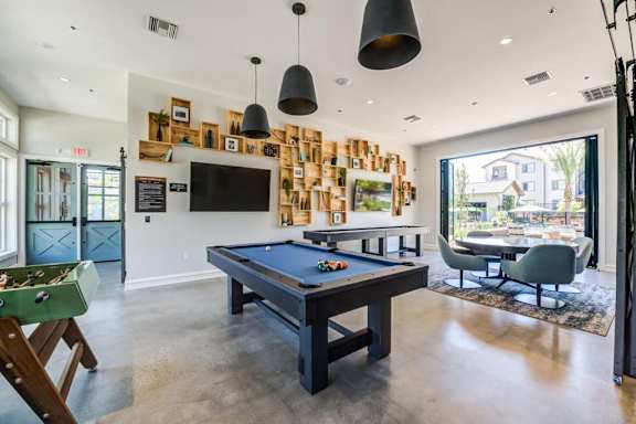 a games room with a pool table and a television at The Vineyards Apartments, California, 91326