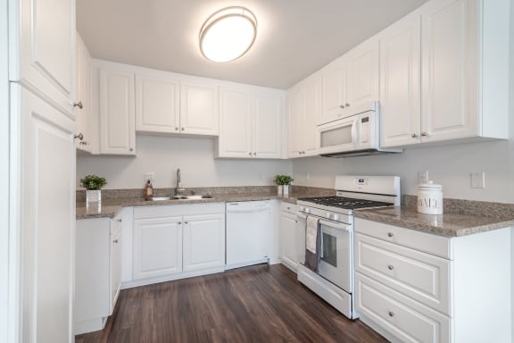 a kitchen with white cabinets and white appliances  at Park Apartments, Norwalk, CA, 90650