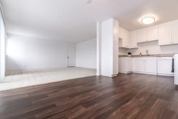an empty kitchen and living room with hardwood floors  at Park Apartments, Norwalk