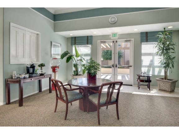 a dining room with a table and chairs