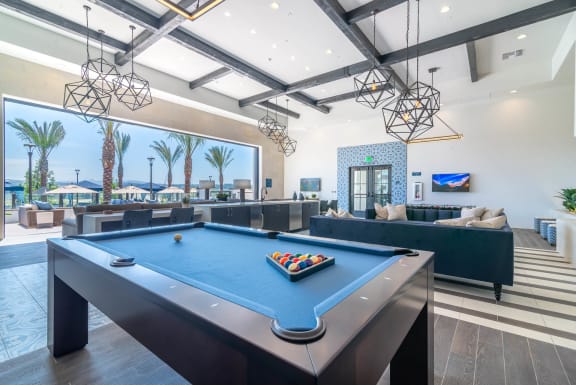 clubhouse with pool table and lounge area at the bradley braddock road station apartments  at Montecito Apartments at Carlsbad, California, 92010
