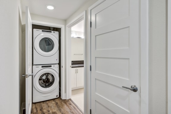 a washer and dryer in a small laundry room at The Vineyards Apartments, Porter Ranch, CA