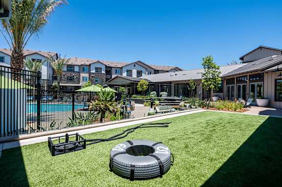 a backyard with a pool and a fire pit