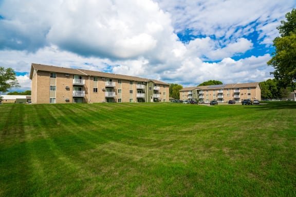 a large lawn in front of an apartment building