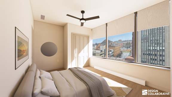 A bedroom with a large bed and a ceiling fan.