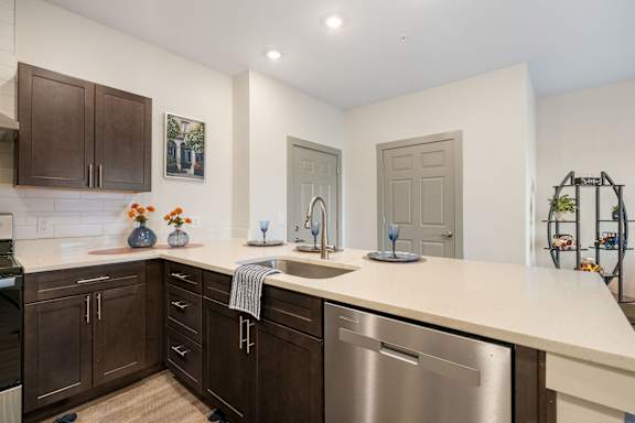 a kitchen with a large counter top and stainless steel appliances at 41 North Senior Living Apartments, Fort Wayne