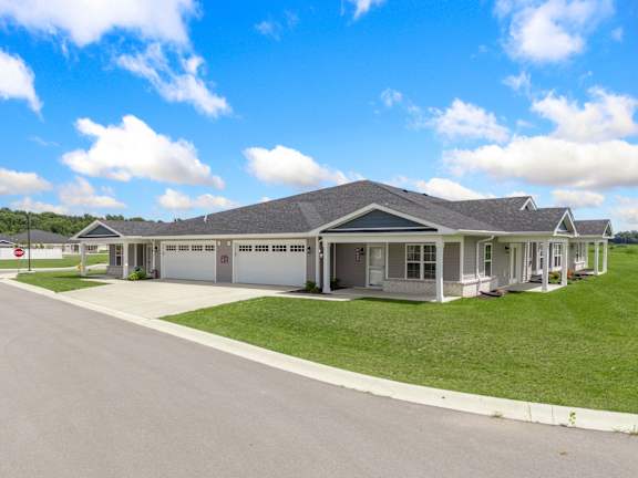 a house with a driveway and lawn in front of it at Morada at Maysville Apartments, Indiana 46815