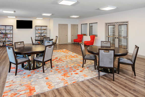 a community room with a table and chairs and a tv at Ritchey Reserve Apartments, Fishers, IN, 46038