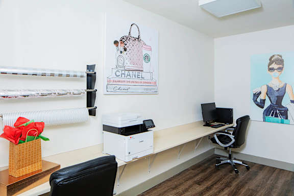 an office with a desk and a printer and a poster on the wall at Ritchey Reserve Apartments, Fishers, IN