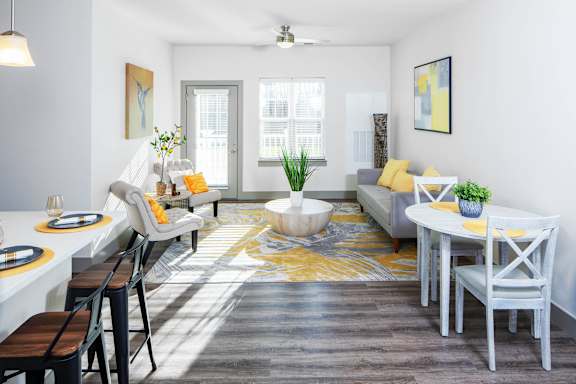 a living room with a dining room table and chairs at Ritchey Reserve Apartments, Indiana 46038