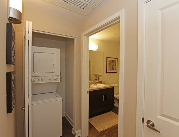 A small kitchen with a microwave and oven built into the cabinetry.