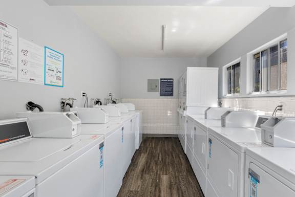 A laundry room with washers and dryers.