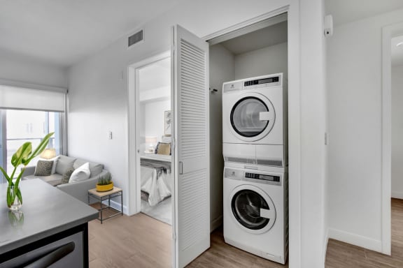 a living room with a washer and a dryer in it
