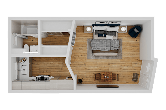 Floor Plan  A top-down view of a small apartment with a bed, couch, and kitchen area.