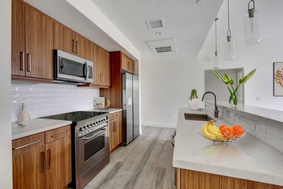 a kitchen with wooden cabinets and white countertops