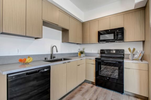 a kitchen with wooden cabinets and black appliances