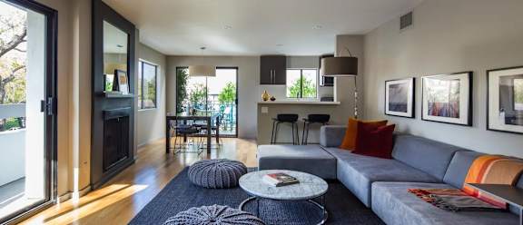 A modern living room with a grey couch and a coffee table.