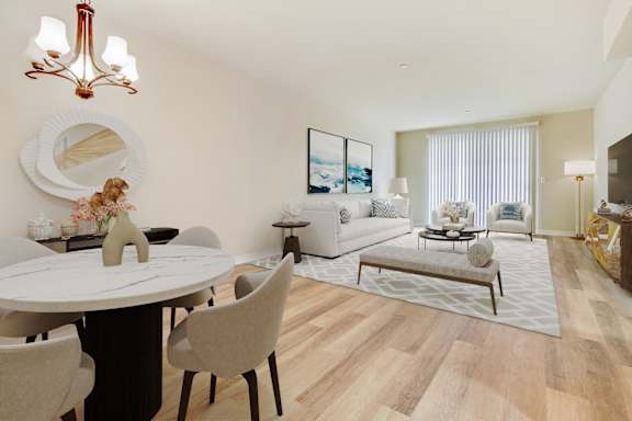 a living room and dining room with a table and chairs