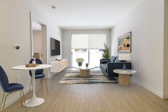 a living room with a couch and a table and a tv at Seventh West Apartments, Santa Monica, 90401