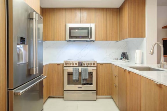 a kitchen with stainless steel appliances and wooden cabinets
