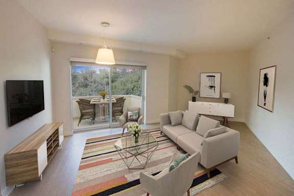 a living room with a couch and a television a living room with a couch and a television at Wilshire Margot, Los Angeles, CA