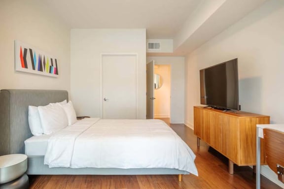 a bedroom with a large bed and a tv