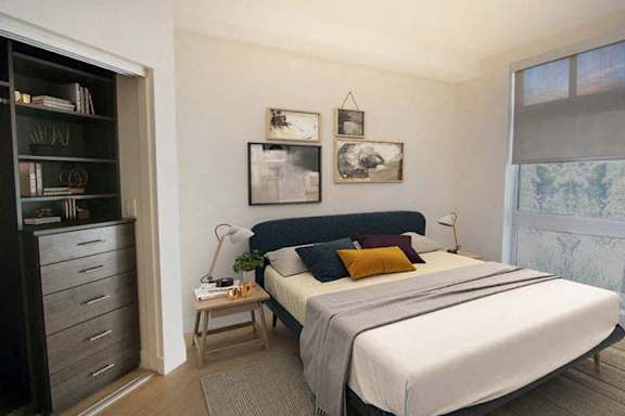 a bedroom with a bed and some pictures on the wall a bedroom with a bed and some pictures on the wall at Wilshire Margot, California