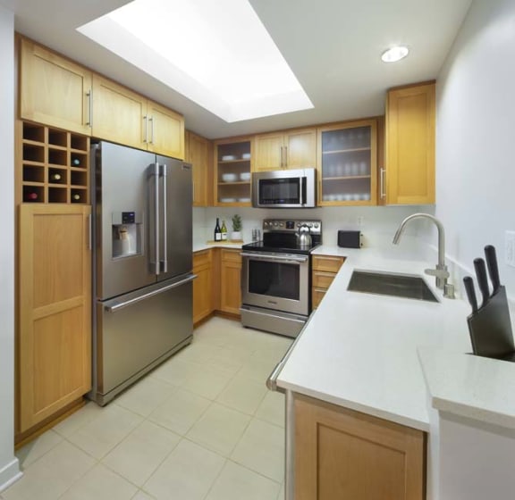 a kitchen with stainless steel appliances and a white counter top