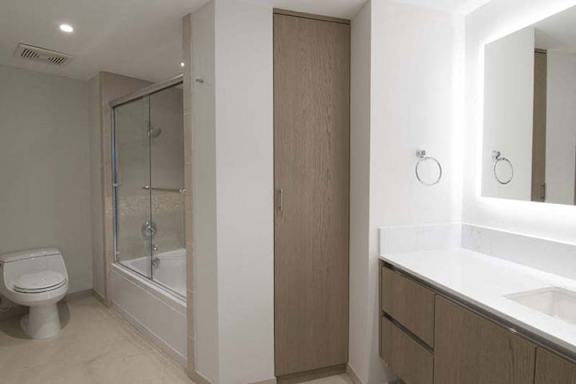 a bathroom with a toilet and a sink and a shower a bathroom with a toilet and a sink and a shower at Wilshire Margot, Los Angeles, CA 90024