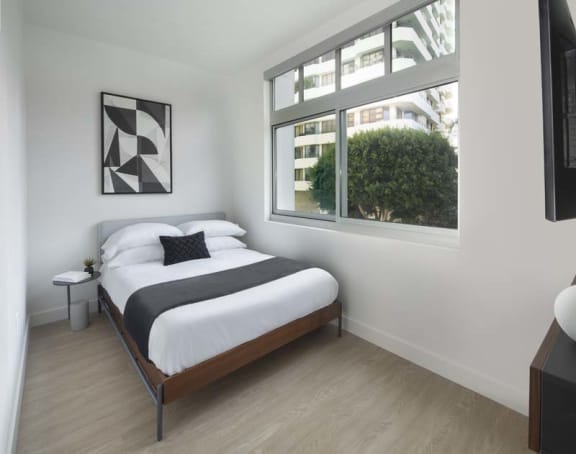 a bedroom with a bed and a window