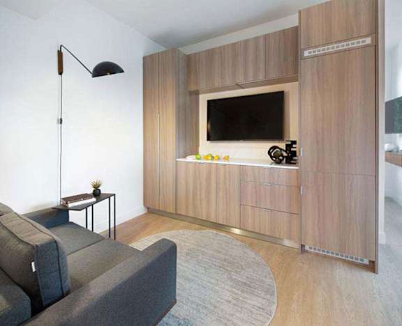 a living room with a couch and a television a living room with a couch and a television at Wilshire Margot, Los Angeles, 90024