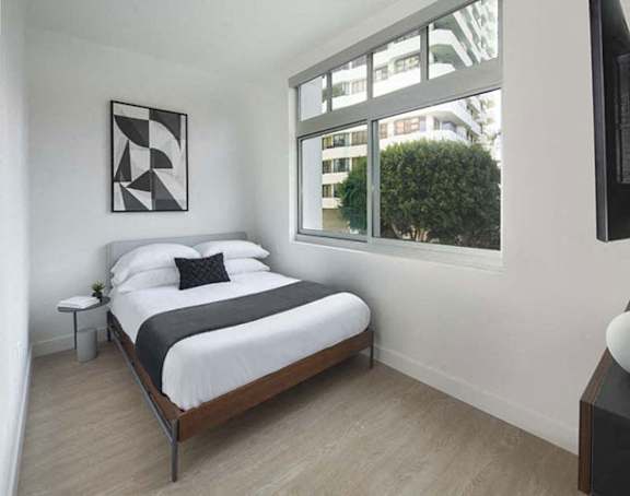 a bedroom with a bed and a window a bedroom with a bed and a window at Wilshire Margot, Los Angeles California