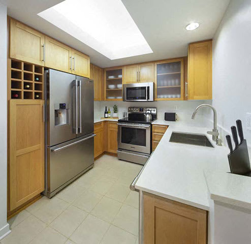 a kitchen with stainless steel appliances and a white counter top a kitchen with stainless steel appliances and a white counter top at Wilshire Margot, Los Angeles, 90024