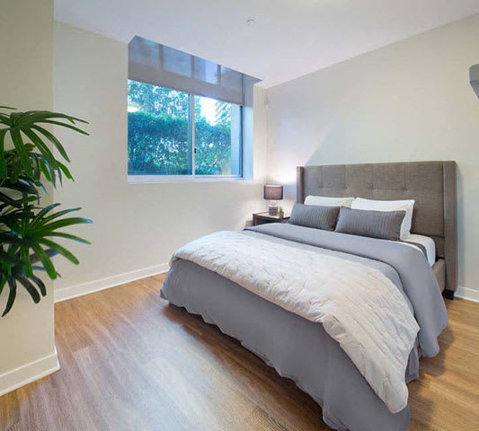 a bedroom with a bed and a window a bedroom with a bed and a window at Wilshire Margot, Los Angeles, CA 90024