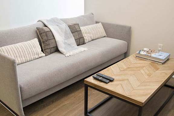a living room with a couch and a coffee table a living room with a couch and a coffee table at Wilshire Margot, California, 90024