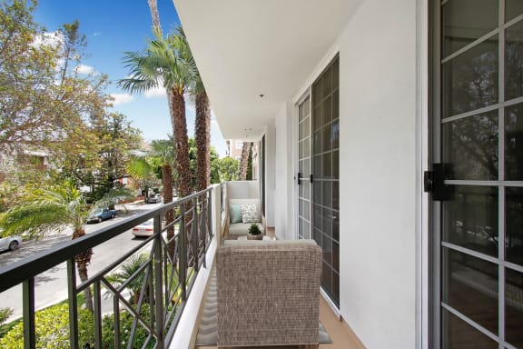 a balcony with a couch and a chair