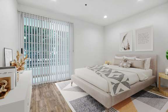 a bedroom with a bed and a large window