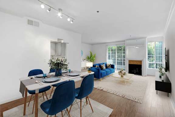 a living room with a dining room table and a fireplace