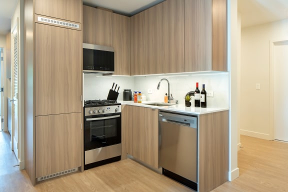 a kitchen with a stove and a sink at The Aster, Los Angeles, CA, 90024