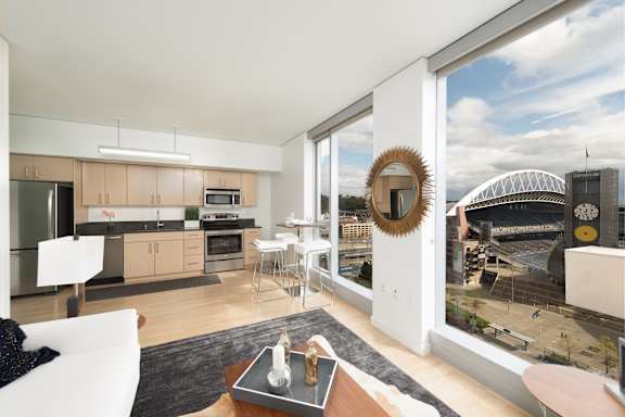 A modern kitchen with a view of a stadium.
