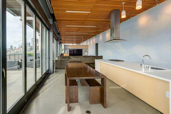 A modern kitchen with a wooden table and chairs.