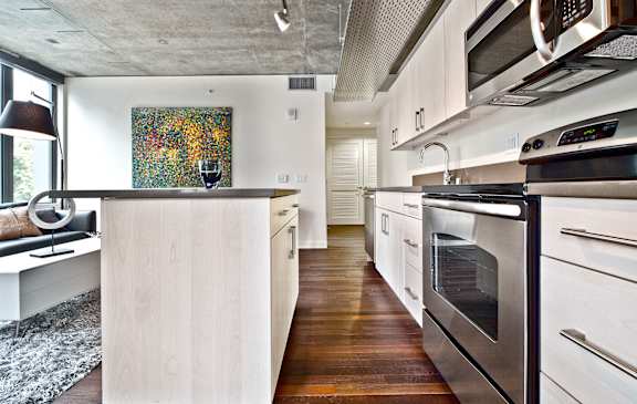 a kitchen with white cabinets and stainless steel appliances