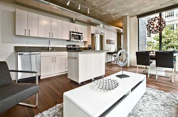 a living room with a kitchen and a dining room