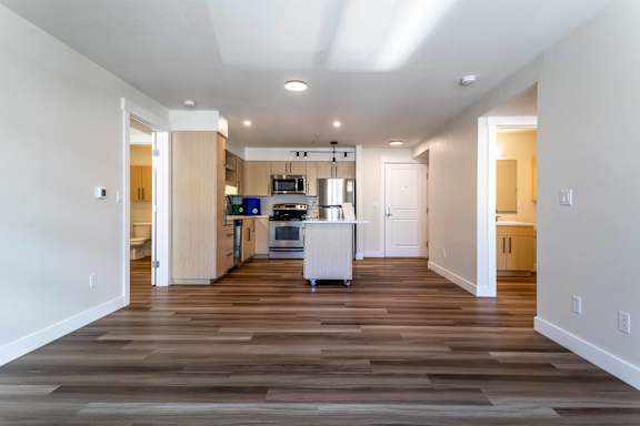 A kitchen with a white fridge and a white dishwasher.