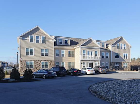 A large building with a parking lot in front of it.