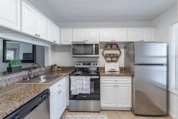 Kitchen with black appliances at Hidden Lakes Apartments, Michigan, 48346