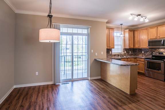 A kitchen with wooden floors and a large island at Highlands at Warwick Apartments, Lilitz, PA