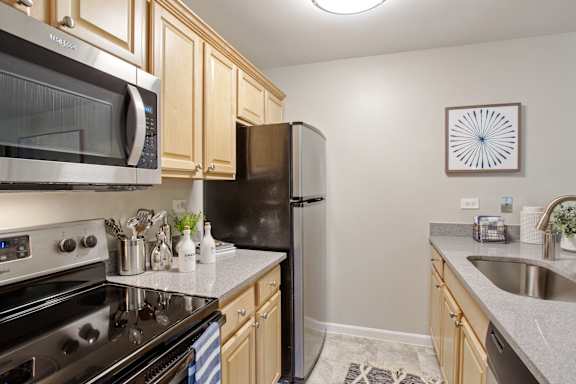 Kitchen with a black refrigerator at fifty9 Grove Apartments, Naperville, IL