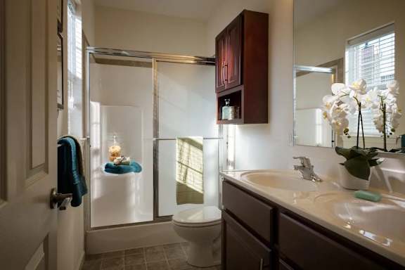 A bathroom with a toilet, sink, and shower at Meridian West Shore, Mechanicsburg, PA 17055